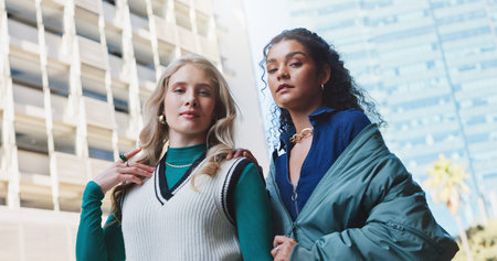 Women, friends and portrait in city with fashion for travel in urban town for education or scholarship with trendy style. People, students and gen z girls with serious confidence in Amsterdam.の写真素材