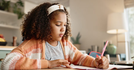 Young girl, student and writing with book in kitchen for homework or assessment at home. Female...