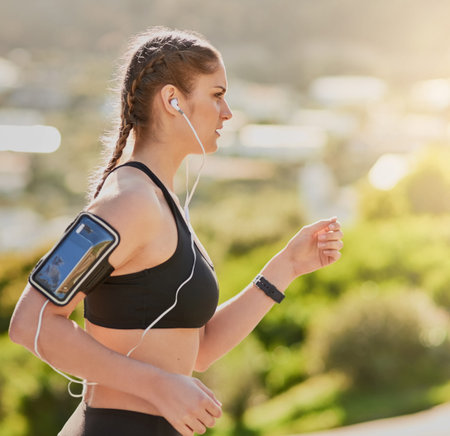 Fitness, music and profile of runner woman outdoor in park for cardio, marathon or training....