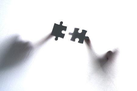 Hands, puzzle or people in studio for problem solving, collaboration and teamwork solution on white...