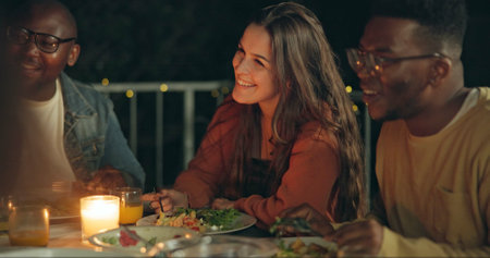 Friends, talking and dinner at party, patio and happy for conversation, food and new years eve celebration. Woman, men and group at table with chat, memory and night with story, diversity and eventの写真素材