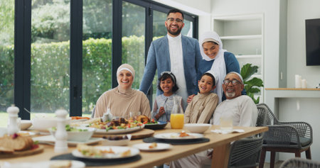 Eid, portrait and smile of family at table in dining room of home together for muslim celebration....