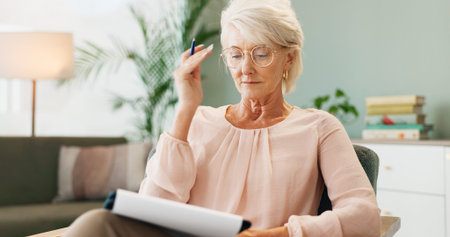 Mature woman, notes and home office with reading, therapy sofa and freelance employee with document....