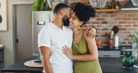 Kitchen, love and happy couple hug in home for bonding, loving relationship or commitment together....