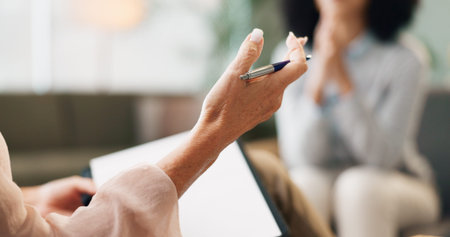 Psychology, therapist and patient or counseling with hands in consultation for mental health support and therapy. Psychologist, discussion and expert advice with evaluation and depression assessmentの写真素材