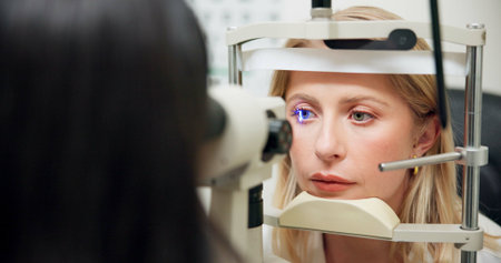 Woman, optometry and slit lamp for check, vision and care in wellness assessment with health at...