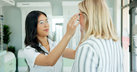 Vision, optometrist and help client with glasses for eye health, wellness or care. Ophthalmology,...
