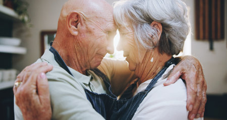Kitchen, love and senior couple in home for embrace, bonding relationship and commitment together....