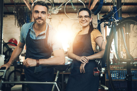 Portrait, employee and bicycle repair shop with smile from mechanic, technician and maintenance...