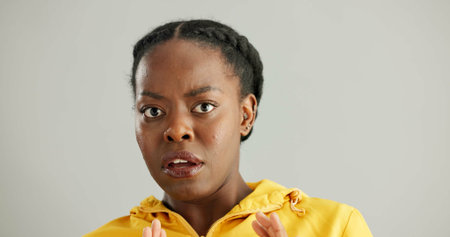 Black woman, scared and studio in portrait with wow, omg surprise or alarm for fake news. Female...