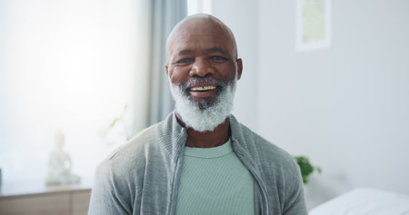 Senior, man and happy with portrait in home for relax, pensioner and confidence in retirement. Elderly, african person and face with smile, pride and good mood for wellness and positive attitudeの写真素材