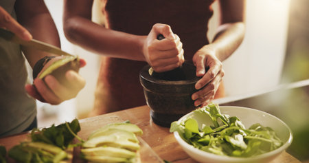 Hands, couple and healthy food in kitchen with avocado, vegetables and leaves for breakfast or...