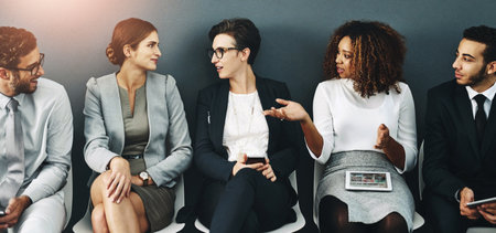 Business people, wall and waiting room for interview with recruitment, hiring or discussion for internship. Group, position and vacancy for employment or human resources with banner, career or hrの写真素材