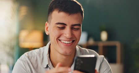 Joke, smile and man with smartphone for online meme with social media, internet gif and reading crazy story in office. Male person, laugh and mobile website for streaming funny video or comedy filmの写真素材