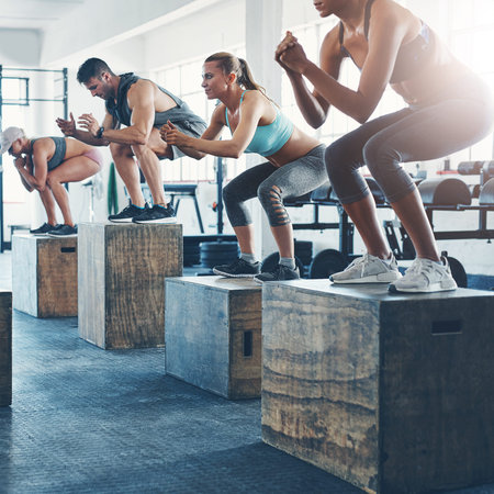 Workout, class and people with jumping in group for exercise, fitness and training for power...
