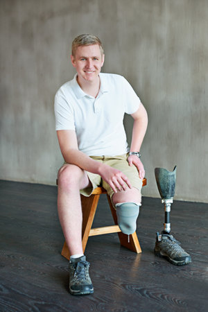 Man, amputee and portrait on chair for fitness, physical rehabilitation and exercise for wellness....