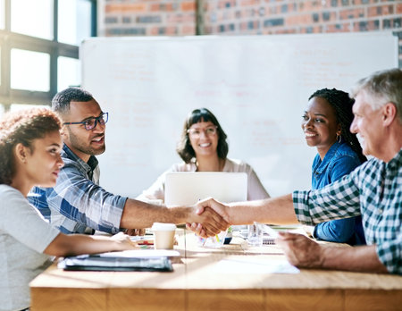 Welcome, hiring or business people with handshake in office for interview intro, deal or negotiation success. Thank you, contract and b2b team shaking hands for onboarding, support or congratulationsの写真素材