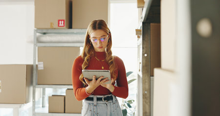 Business woman, tablet and planning of package for e commerce courier service, logistics and stock inventory. Entrepreneur or seller with checklist on digital tech for online shop or sales by boxesの写真素材