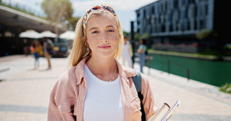 Woman, portrait and outdoor smile at university, books for education or learning on campus. Female...