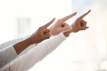 Hands, group and point at business for choice, direction and people for promotion, opportunity or recruitment. Team, gesture and sign for offer, guide and decision with vote with staff in workplaceの写真素材