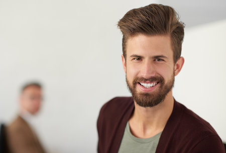 Businessman, portrait and happiness for creative employee in startup with graphic designer in modern office or workplace. Face, man and small business with confidence, smile and entrepreneurshipの写真素材