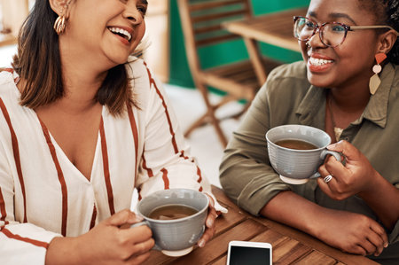 Laughing, women or friends in coffee shop for talking, conversation or discussion in restaurant....