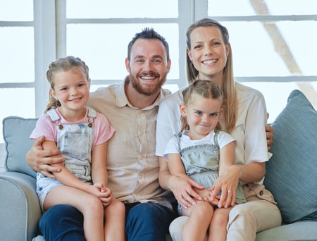 Family, smile and parents with children in portrait, happiness and together in home living room. People, bonding or love with care, mother and father relax with kids on house couch or sofa in loungeの写真素材