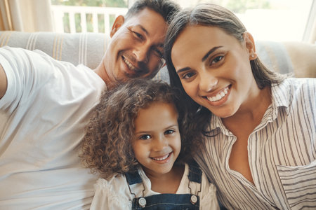 Family, girl and portrait with selfie on sofa for personal blog, profile picture and social media for memory. Mom, father and kid with photography in living room of home with love or content creationの写真素材