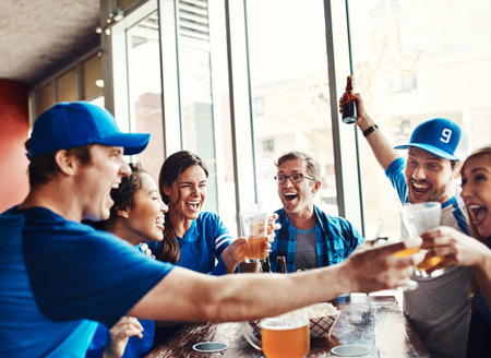 Sports, fans and cheers with drinks for celebration, support and people watching tv team game in restaurant. Friends, cheering and live streaming with happiness, excited and pride for baseball winの写真素材