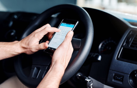 Hands, person and driving car with phone for calendar, schedule or date for delivery service on...