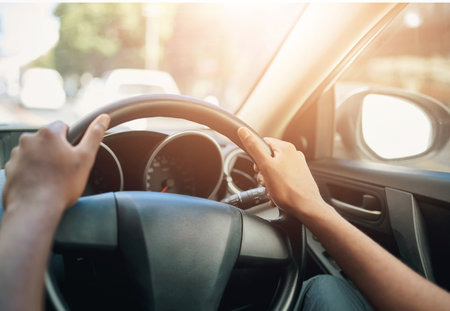 Hands, person and steering wheel of car to drive, travel and road trip for outdoor driving on transportation direction. Drive, ride and vehicle for motor, auto and windshield for adventure in cityの写真素材
