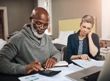 Mature couple, accounting and document for planning finance, retirement funding and investment or asset management at home. Budget, elderly man and woman with information, writing and pension savingsの写真素材