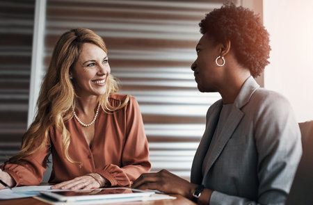 Business meeting, tablet and women with documents in office for planning, research or financial report or review. Economy, problem solving or accountant consulting mentor with inflation solution ideaの写真素材
