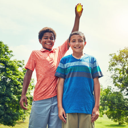 Water balloon, smile and portrait of children in garden with games, bonding and outdoor holiday in park. Playing, kids and happy friends with fun, nature and adventure on summer vacation in backyard.の写真素材