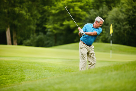 Mature man, happy and swing at golf course with sports for talent, retirement and training. Hobby, activity and smile in field or club for practice, fitness and exercise for health with fun on breakの写真素材