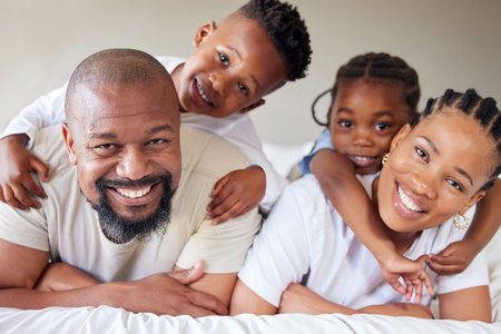 Portrait, black family and children in bedroom for bonding, together for happiness in home on weekend. Woman, man and kids with hug, love and affection for memory, growth and development as parentsの写真素材