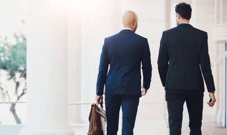 Lawyer, walking and business men in city for legal trail, visa application or naturalization. Back, immigration and attorney with client at court to file petition, citizenship or asylum seekerの写真素材