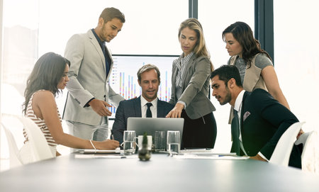 Team, people and laptop for brainstorming in company as consultant in accounting firm or bank in workshop or office. Group, business meeting and tech in collaboration for growth or career in financeの写真素材