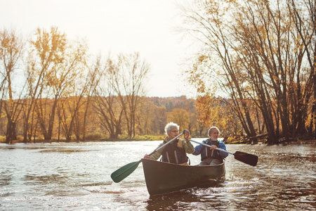 Lake, senior couple and kayaking in nature with canoe for explore, adventure or retirement activity....