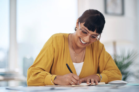 Writing, notebook and woman in office with smile, administration and ideas for research report. Notes, pen and happy consultant at desk with business plan, documents and professional with proposalの写真素材