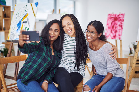 Selfie, workshop and painter group together for social media post, memories and sharing on internet. Creative, students and mobile tech in gallery for design lesson, passion project or talentの写真素材