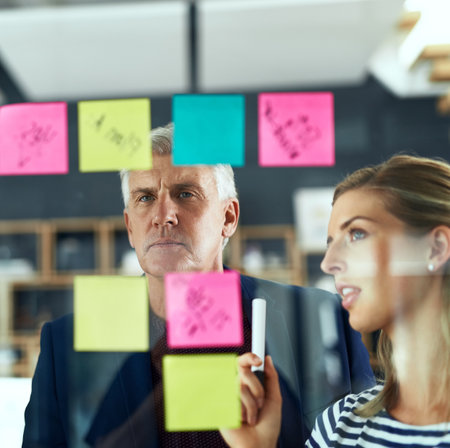 Thinking, brainstorming or business woman with mature mentor planning in office for calendar, solution or presentation. Coaching, agenda or ceo with manager for training, vision or project objectivesの写真素材