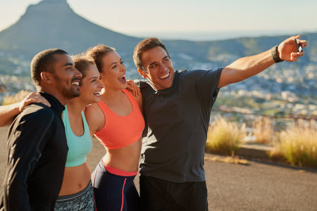 Group, selfie and happy for fitness by mountain on road with diversity, running and hug for memory. Friends, men and women with training, photography and profile picture for social media in morningの写真素材