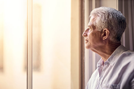 Senior man, home and thinking on window with memories or reflection on retirement, break and chill....