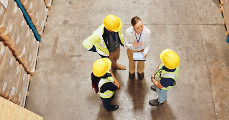 Logistics, tablet and industrial people with teamwork for warehouse planning, ecommerce or supply chain training. Group or leader above with digital software for courier, shipping or stock managementの写真素材