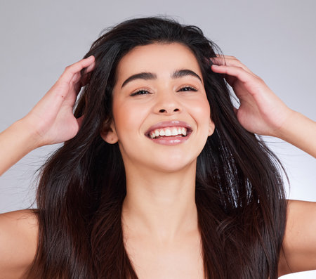 Studio, hair care and woman in portrait with hands, keratin treatment or clear skin on white background. Female person, skincare and natural beauty with cosmetics for growth, wellness or makeupの写真素材
