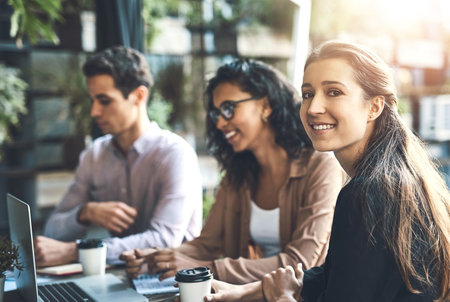 Business people, portrait and woman in meeting, laptop and connection with planning, teamwork and feedback. Face, employees and agent with pc, review and cooperation with ideas, internet and projectの写真素材