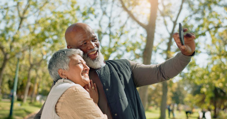 Senior couple, selfie and love in park with hug or happy of outdoor photography for holiday, travel...