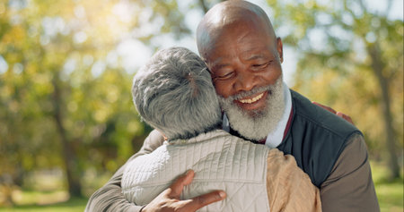 Happy senior couple and hugging outdoor at park for commitment, relationship and bonding together. Smile, man and woman with love embrace for care, support and dedication to marriage in natureの写真素材