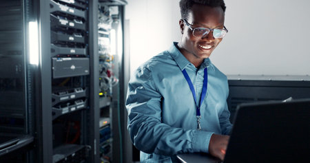 Laptop, server room and technician programming software, update or system network maintenance....